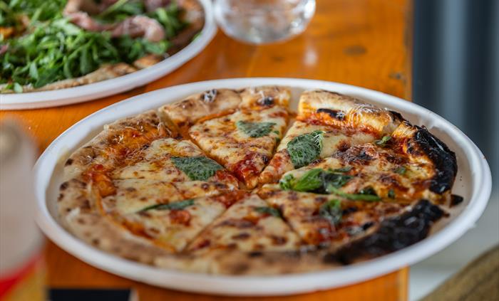 Sourdough pizza on a table at Silver Circle Distillery